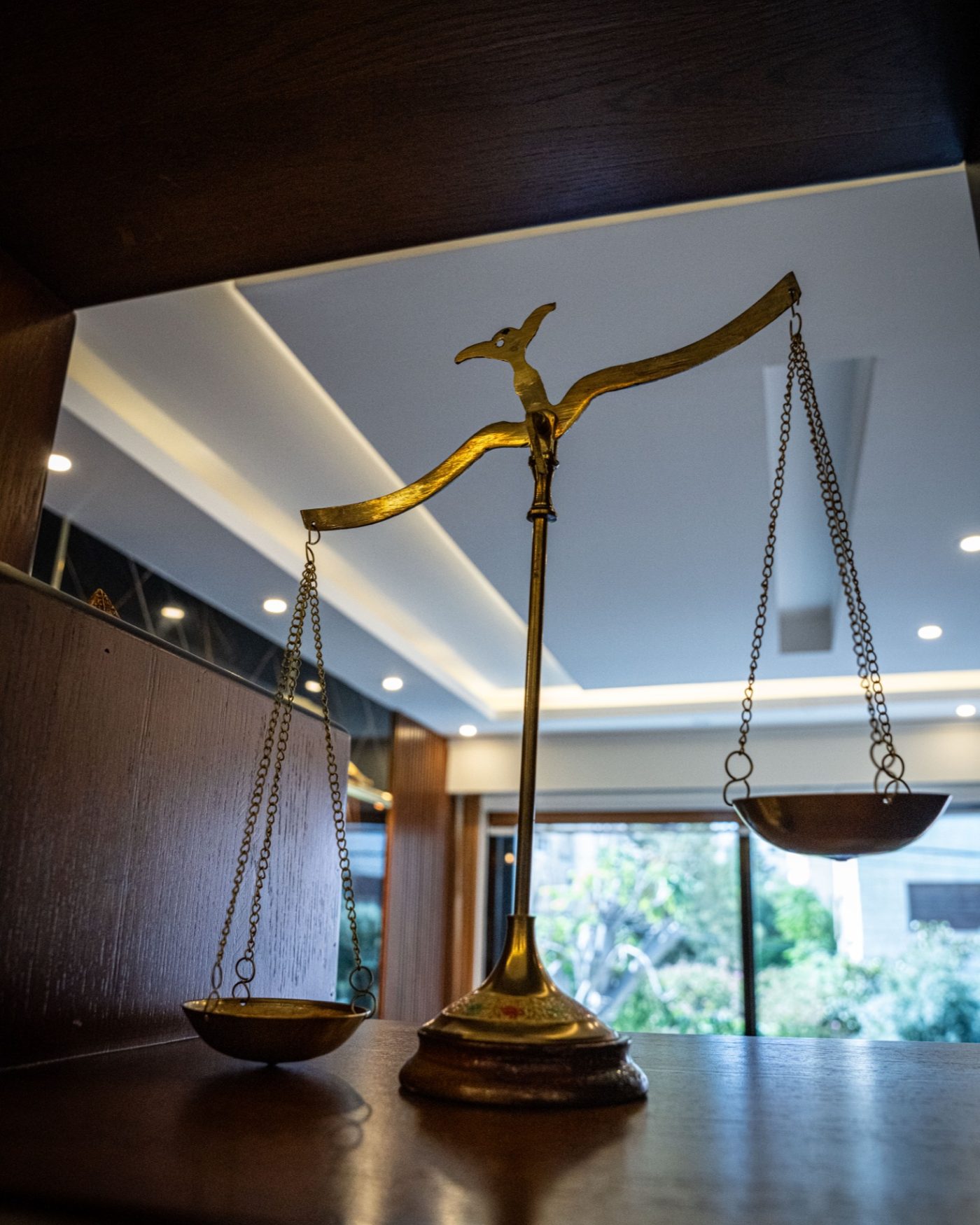 A brass balance scale on a boardroom table in the firm's Amman office.